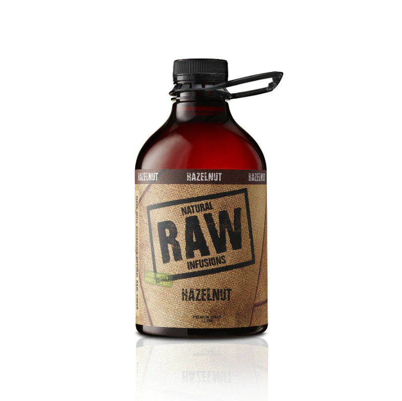 Raw hazelnut coffee syrup from Horse and Harpy in a 1-liter bottle, showing the clear plastic container with the dark syrup inside.